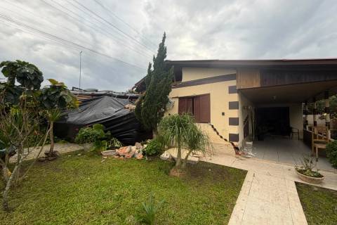 Caminhão tomba e atinge residência na marginal da BR-101