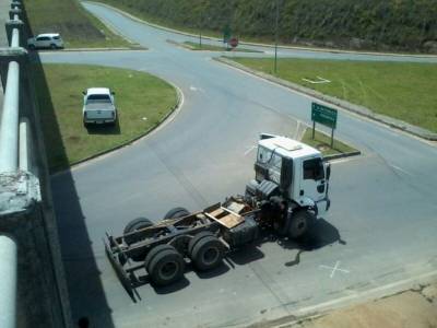 Motorista “engalha” caçamba de caminhão em viaduto