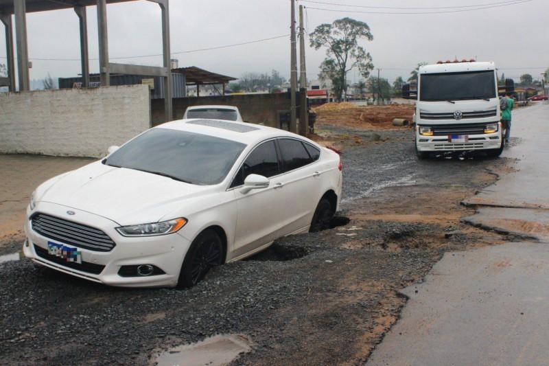 Carros e motocicleta caem em buraco durante chuva em Criciúma; veja fotos e vídeos